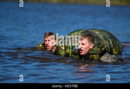 U.S. Army Capt. James McClare (right), and 1st Lt. Anthony Day (left), 10th Mountain Division, swim towards the next event after jumping from a HH-60 Pave Hawk during the Best Ranger Competition 2016 at Fort Benning, Ga., April 17, 2016. The 33rd annual BRC 2016 is a three-day event consisting of challenges to test competitor's physical, mental, and technical capabilities.  Senior Airman Keith James Stock Photo