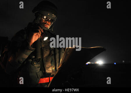 Staff Sgt. Nathan Patrick, 8th Maintenance Operations Squadron readiness support team member, looks at a map while running his route during exercise Beverly Bulldog 11-3, at Kunsan Air Base, Republic of Korea, Nov. 17, 2011. The readiness flight plans for and assists in protecting people and assets during disasters, major accidents and hostile actions. They help ensure rapid response to and recovery from the effects of such incidents.  Senior Airman Brittany Y. Auld Stock Photo