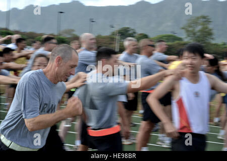 Sgt. Maj. Ray Powers, 82 Rear Operations Command Sergeant Major, Oregon Air National Guard sprints past his team during a relay race as part of bilateral training exercise Tiger Balm July 15, 2012 at the Regional Training Institute, Waimanalo, Hawaii. This exercise between the Singapore Armed Forces and the U.S. Military is designed to help foster professional military relations between the two countries and to increase strategic interoperability. Stock Photo