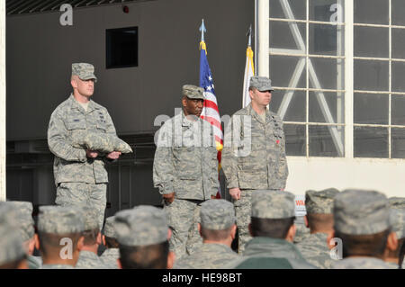 Lt. Col. Jeremy Simmons (center), 144th Civil Engineer Squadron (CES), California Air National Guard, awards the Bronze Star medal to Tech. Sgt. Jason Ganner (right), an explosive ordnance disposal craftsman assigned to the 144th CES, for his meritorious service as a team leader while assigned to Joint Force Paladin East in the Ghanzi Province, Afghanistan.  The medal was presented during a 144th Fighter Wing's Enlisted Call on March 3, 2012. Stock Photo