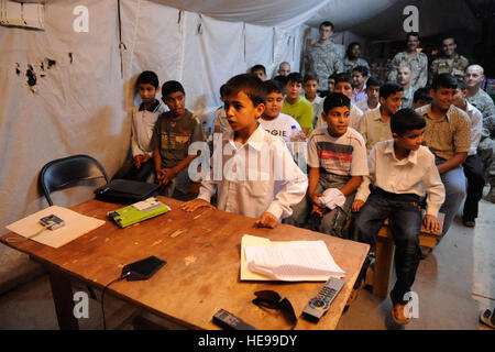 An Iraqi student from Al Enteserat primary school asks a question to students at Meadows Elementary School, Fort Hood, Texas, via video teleconference call at Joint Security Station Ezdehar on May 22. Stock Photo