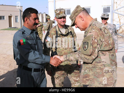 Brig. Gen. Tom Cosentino (right), NATO Training Mission-Afghanistan's deputy commander for Mission Support greets Regional Logistics Center commander, Afghan National Police Maj. Mohammad Nadin at the Joint Regional Afghan National Police Center, Sept. 19, 2011, Kandahar, Afghanistan. Brig. Cosentino spent two days visiting sites and people in southern Afghanistan. Stock Photo