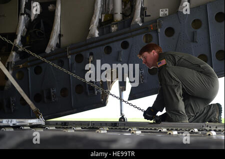 Staff Sgt. Seth Dunworth, 437th Airlift Wing instructor loadmaster, chains down cargo May 20, 2016, on Buckley Air Force Base, Colo. The cargo being chained down is a spacecraft Origins-Spectral Interpretation-Resource Identification-Security-Regolith Explorer which is being transported to Cape Canaveral, Florida, where it will be launched in September.  Airman 1st Class Luke W. Nowakowski Stock Photo