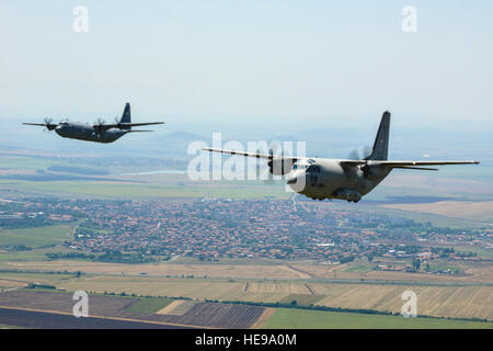 An U.S. Air Force C-130J Super Hercules and a Bulgarian air force C-27J Spartan fly in formation over Plovdiv, Bulgaria, July 16, 2015. The formation flight was a part of a two-week-long bilateral training exercise. More than 100 allied service members jumped from three C-130J’s and one C-27J. Senior Airman Nicole Sikorski) Stock Photo