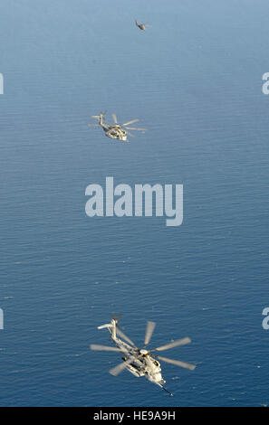 U.S. Marine Corps CH-53 Super Stallions from Marine Heavy Helicopter 464 Detachment A and a U.S. Air Force HH-60 Pave Hawk from the 303rd Expeditionary Rescue Squadron resume formation after refueling from an MC-130P Combat Shadow from the 81st Expeditionary Rescue Squadron during a mission over Djibouti Jan. 29, 2013. The refueling mission provided a familiarization flight for the new 303rd ERQS aircrews prior to gaining operational responsibility from the redeploying HMH-464 Detachment A. The Pave Hawks bring additional capability to the personnel recovery mission at Combined Joint Task Forc Stock Photo