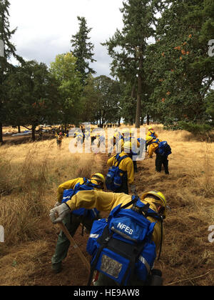 Members of the Oregon Air National Guard are training on equipment they will be using while assisting the wildland firefighters in cleanup operations Aug. 29, 2015 in Salem, Ore. To assist with firefighting efforts across the state, 125 Oregon ANG members were activated by the governor. Fifty-four of those Airmen were from the 173rd Fighter Wing at Kingsley Field, Ore. () Stock Photo