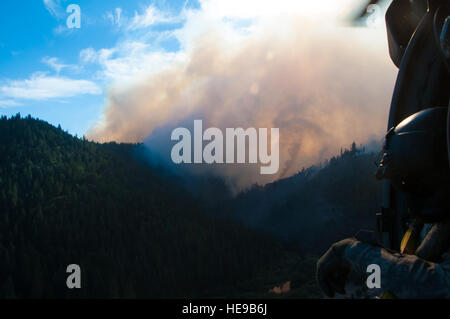 Chief Warrant Officer Chris Aylstock, Capt. Colton Brauer, Sgt. Chris Boni, of the 1-140th Aviation Battalion (Air Assault)  out of Los Alamitos and Scott Corn, Cal Fire manager battle the Rim wildfire over Yosemite National Park, Aug 22, 2013. The California National Guard UH-60 Black Hawk and HH-60 Pave Hawks are in full force supporting the US Forest Service and Cal Fire in California. (U.S. California  Master Sgt. Julie Avey/ Released) Stock Photo