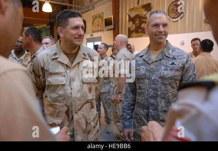 Camp Lemonier's Command Master Chief, CMDCM Mark Cummings, left, and U.S. Air Force Chief Master Sgt. Martin Klukas, right, the senior enlisted leader for Combined Joint Task Force-Horn of Africa, engage in conversation with Japanese service members during a reception forthe recently arrived Japanese Maritime Self-Defense Force. The JMSDF have deployed two P-3C aircraft which are expected to become part of a multinational effort to stabilize the waters of the Gulf of Aden. Stock Photo