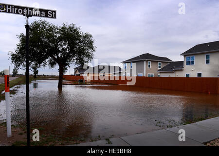 Flood water pools along homes after a severe weather storm May 5, 2015 at Cannon Air Force Base, N.M. Air commandos and their families weathered the brunt of a colossal storm that flooded homes and other base facilities. Staff Sgt. Matthew Plew) Stock Photo