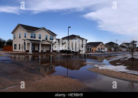 Flood water pools along homes after a severe weather storm May 5, 2015 at Cannon Air Force Base, N.M. Air commandos and their families weathered the brunt of a colossal storm that flooded homes and other base facilities. Staff Sgt. Matthew Plew) Stock Photo