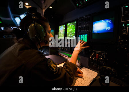 U.S. Air Force Capt. Ashley Mayes, 71st Rescue Squadron combat systems officer, performs duties on board an HC-130J Combat King II, Feb. 4, 2016, in the skies over Moody Air Force Base, Ga. Combat systems officers rely on a wide range of high-tech equipment and weaponry to provide navigation and weapons systems support to accomplish their missions.  Senior Airman Ryan Callaghan Stock Photo