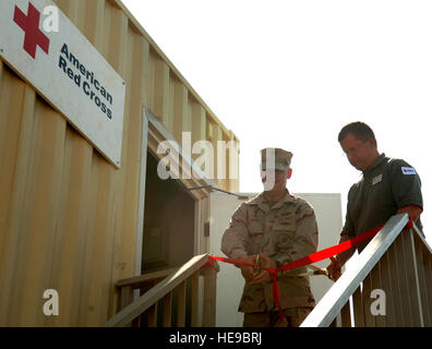 U.S. Navy Capt. Scott Hurst, Camp Lemonnier commander, and Jason Marshall, Camp Lemonnier Red Cross coordinator, cut the ribbon of the first Red Cross office on Camp Lemmonier, Sept. 28. In addition to providing emergency communication for military personnel and their families, the Red Cross will also work with the Morale Welfare and Recreation office to enhance morale services on camp. Stock Photo