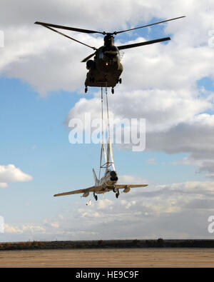 A CH-47 'Chinook' helicopter, operated by the 1/189th Aviation, Nevada Army National Guard airlifts a Korean War-era F-86 L 'Sabre' into the Wendover Airport in Utah on Nov. 5.  The F-86 was being transported from the Battle Mountain Airport, located in Nevada to its new home at the historic Wendover Airfield Museum.  The plane will be refurbished and used as a static display that will be open to the general public.  Historic Wendover Airfield Foundation board member Jim Peterson said that the plane will be painted up with markings from the 191st Fighter-Interceptor Squadron, Utah Air National Stock Photo