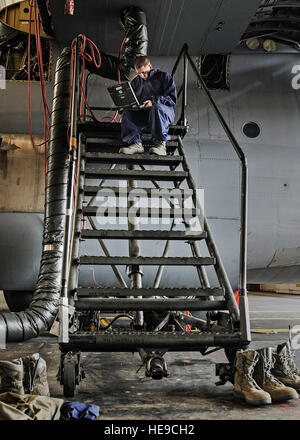 A fuels system repair technician from the 19th Maintenance Group diagnoses malfunctions using a laptop at Little Rock Air Force Base, Arkansas, on May 27, 2014, maintaining fuel, water, bladder, and external tanks. Stock Photo