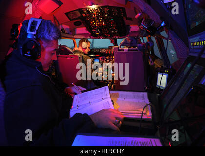 ALTUS AIR FORCE BASE, Okla. – French air force Capt. Aurélien Leray performs a preflight checklist while his instructor, U.S. Air Force Lt. Col. (ret.) Tony Valerio reviews his notes during a simulated flight Nov. 8, 2013. Leray is one of the first French pilots to travel to Altus AFB for training on the KC-135 Stratotanker.  Senior Airman Levin Boland/Not Released) Stock Photo