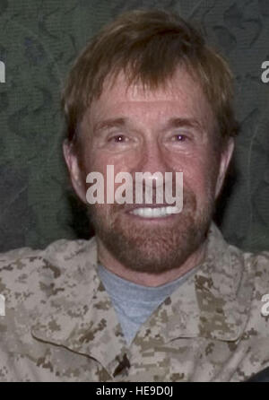 SOUTHWEST Asia -- Security Forces Airmen with the 386th Air Expeditionary Wing, pose for a photograph with Walker, Texas Ranger star, Chuck Norris who is currently visiting troops in Southwest Asia.  Before becoming a celebrity, Mr. Norris was a Security Forces member in the United States Air Force.  ( Staff Sgt. Tia Schroeder) Stock Photo