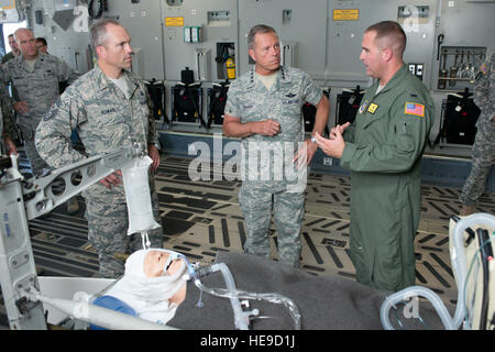 While on board a C-17 Globemaster III at Travis AFB, Calif., Command Chief Master Sgt. Martin S. Klukas and Gen. William M. Fraser III listen to 1st Lt. Chris Lindsey, 60th Medical Group critical care nurse, describe how the 60th Air Mobility Wing saves lives through air medical evacuation. (Air Force photo/Ken Wright) Stock Photo