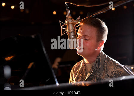 Airman 1st Class Jamie Teachenor, the U.S. Air Force Academy Band and Wild Blue Country lead vocalist, rehearses his songs at Peterson Air Force Base, Colo., July 20, 2016. Before joining the Air Force, Teachenor was a multi-platinum singer and songwriter based in Nashville, Tenn. Airman 1st Class Dennis Hoffman) Stock Photo