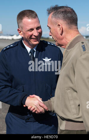 Marine Corps Gen. Joseph F. Dunford, the chairman of the Joint Chiefs of Staff, greets Air Force Lt. Gen. John Dolan, U.S. Forces, Japan commander, during his visit to Yokota Air Base, Japan, Nov. 3, 2015. The generals left Yokota to visit with members of the Japan Self-Defense Forces and the U.S. Embassy in downtown Tokyo.  Staff Sgt. Cody H. Ramirez Stock Photo