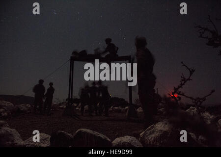 U.S. military personnel assigned to Combined Joint Task Force-Horn of Africa (CJTF-HOA), along with French Foreign Legion soldiers, negotiate an obstacle course as part of a desert commando course in Arta, Djibouti, March 15, 2016. Through unified action with U.S. and international partners in East Africa, CJTF-HOA conducts security force assistance, executes military engagement, provides force protection, and provides military support to regional counter-violent extremist organization operations in order to support aligned regional efforts, ensure regional access and freedom of movement, and  Stock Photo