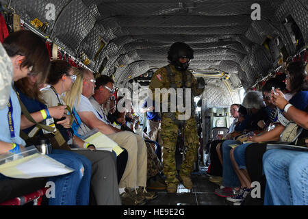 The air crew on a CH-47 Chinook helicopter instructs patients how to secure themselves in the aircraft during the annual National Disaster Medical System training exercise August 17, 2016, at Denver International Airport. The air crews transported over 100 patients from the DIA to Denver area hospitals.  Airman 1st Class Gabrielle Spradling Stock Photo