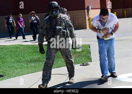 The air crew with a UH-60 Black Hawk helicopter guides patients onto the aircraft during the annual National Disaster Medical System training exercise August 17, 2016, at the Lutheran Medical Center in Wheat Ridge, Colo. The air crews were responsible for facilitating safe landing and take-off procedures, and dropping off and picking up patients from Denver area hospitals.  Airman 1st Class Gabrielle Spradling Stock Photo