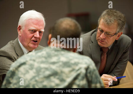 Arnor Sigurjonnson, National Representative to NATO for Iceland, and Jon Gudnasson, Chief of Integrated Air Defense System, questions U.S. Army Lt. Col. Chad Jackson, Combined Endeavor test director, at the Joint Interoperability Testing Command (JITC) during CE 2012, Joint Multinational Training Command, Grafenwoehr, Germany, Sept. 19, 2012. JITC enables international interoperability by maintaining a database of information obtained from participating countries from the last 18 years of CE's existence. CE12 is a multinational command, control, communications and computer systems exercise des Stock Photo