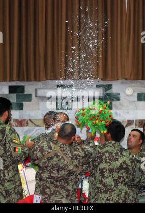 Twenty Afghan National Army soldiers and two Afghan National Police officers celebrate June 5, 2010, following their achievement as the second class of Senior Bridmals to graduate from the ANA Sergeants Major Course.  More than 200 Afghan, U.S. and Coalition forces gathered at the Kabul Military Training Center in Kabul, Afghanistan to watch Class 002-10, comprised of E-8s/-9s, receive their graduation certificates. Stock Photo