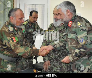 100316-1489D-F-003: FORWARD OPERATING BASE THUNDER, Afghanistan – Deputy Religious Cultural Advisor Col. Farooq, is presented his certificate of completion by Afghan National Army Chief of Staff, Brig. Gen. Mir Saheb Gul as RCA Col. Sayeed Waqif Shah looks on.   A training seminar conducted by the Wise Corporations at FOB Thunder, took place Mar. 14-16. The training better equipped the attendee with skills to communicate with the public through the media. Attendees included spokespersons from the Afghan National Army, Border Patrol and Police, the National Directorate of Security, local Afghan Stock Photo