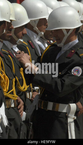 Qargha, Afghanistan (6 Apil, 2001) -- Cadets from the National Military Academy Afghanistan look over each other's uniforms to make sure everything's in order while awaiting arrival of the official party for the cornerstone laying ceremony of the NMAA. This ceremony established the NMAA and Defense University at Qargha.  Staff Sgt. Jeff Nevison) Stock Photo