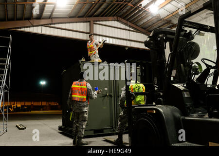 U.S. Air Force Airmen with the 437th Aerial Port Squadron tie down pallets of cargo during Crescent Reach 15 here May 19, 2015. This local exercise, which lasted from May 18-21, 2015, tested and evaluated Joint Base Charleston's ability to launch a large aircraft formation in addition to process and deploy duty passengers and cargo in response to a simulated crisis abroad. Deploying members' ability to survive and operate in deployed environments was also exercise through Chemical, Biological, Radiological, Nuclear Explosives training and evaluation events.  Senior Airman Nicholas Byers) Stock Photo