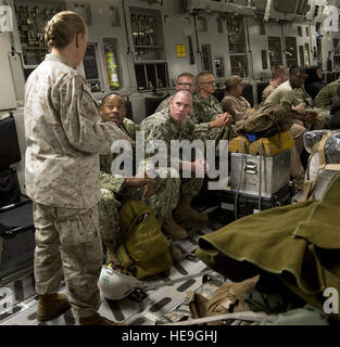 U.S. Marine Corps Sgt. Maj. Bonnie Skinner, Combined Joint Task Force-Horn of Africa command senior enlisted leader, speaks with Naval Mobile Construction Battalion (NMCB) 133 Detail Horn of Africa Seabees on board a C-17 Sept. 19, at Camp Lemonnier, Djibouti. Fifteen Seabees from NMCB-133 will travel to Monrovia, Liberia, in support of Operation UNITED ASSISTANCE to conduct site surveys, construct a $22 million hospital and stockpile it with supplies to support training of healthcare workers fighting the Ebola outbreak.  Staff Sgt. Leslie Keopka Stock Photo