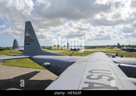 U.S. Air Force Reserve, Guard and active duty C-130H and C-130J Hercules aircraft crews from U.S. bases worldwide, prepare their airframes at Cherbourg-Maupertus Airfield, France prior to flying over the beaches of Normandy, France on June 5, 2014 prior to crews performing flyover missions in Normandy, France. The flyovers preceded a massive airdrop of over 1,000 paratroopers as part of the 70th anniversary commemoration of the D-Day landing in Normandy.  Tech. Sgt. Erica J. Knight Stock Photo