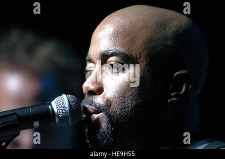 YOKOTA AIR BASE, Japan -- Darius Rucker, lead singer of Hootie and the Blowfish, sings to a crowd during an Operation Pacific Greetings tour concert here May 19.  The tour features performances by Band of the U.S. Air Force Reserve, the Pacific Air Force Band-Asia and New England Patriots' cheerleaders.   Master Sgt. Val Gempis) Stock Photo