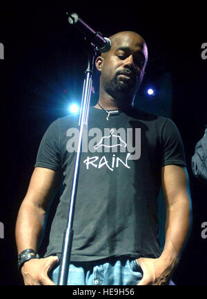 YOKOTA AIR BASE, Japan -- Darius Rucker, lead singer of Hootie and the Blowfish, listens to Staff Sgt. Tami Bonne sing 'Amazing Grace' during an Operation Pacific Greetings tour concert here May 19.  Sergeant Bonne is a vocalist from the Band of the U.S. Air Force Reserve at Robins Air Force Base, Ga.  Besides performances by Hootie and the Blowfish, the tour also features the Pacific Air Force Band-Asia and New England Patriots' cheerleaders.   Master Sgt. Val Gempis) Stock Photo