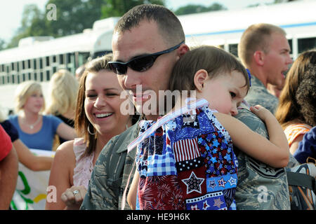 Family members of deployed 169th Fighter Wing Airmen, greet their airmen as they arrive to McEntire Joint National Guard Base, S.C., over 200 members of the 169th Fighter Wing return home Aug. 29, 2010, after a 120-day deployment to Iraq. The 169th Fighter Wing detachment was assigned to the 332nd Air Expeditionary Wing at Joint Base Balad, Iraq. While assigned to the 332nd AEW, the men and women of the 169th Fighter Wing generated and flew more than 800 combat air patrol missions over Iraq from May through August. Stock Photo