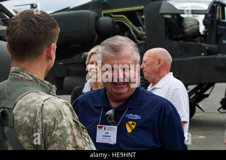 A U.S. Army Soldier, assigned to 16th Combat Aviation Brigade, 7th Infantry Division, talks to a Vietnam Veteran during a visit at Joint Base Lewis-McChord, Wash., May 20, 2016. The Angry Skipper Association is a group of Vietnam-era aviators who served with Delta Company, 2nd Battalion, 8th Cavalry Regiment, 1st Cavalry Division (Airmobile). Stock Photo