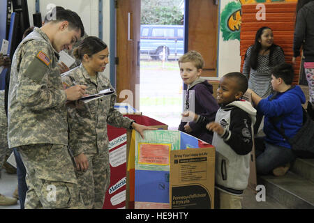 U.S. Army Soldiers assigned to 16th Combat Aviation Brigade judge a science fair at Tillicum Elementary School in Lakewood, Wash., Feb. 4. This event was part of 16th CABs ongoing efforts in the community dedicated to maintaining a strong partnership with local citizens. Stock Photo