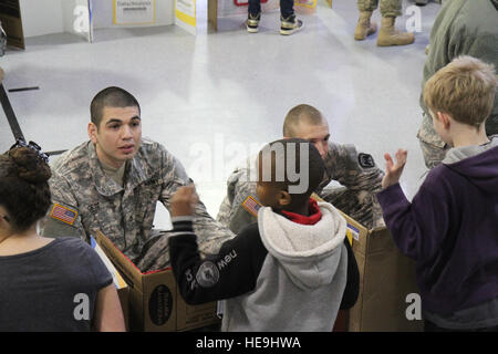 U.S. Army Soldiers assigned to 16th Combat Aviation Brigade judge a science fair at Tillicum Elementary School in Lakewood, Wash., Feb. 4.  This event was part of 16th CABs ongoing efforts in the community dedicated to maintaining a strong partnership with local citizens. Stock Photo