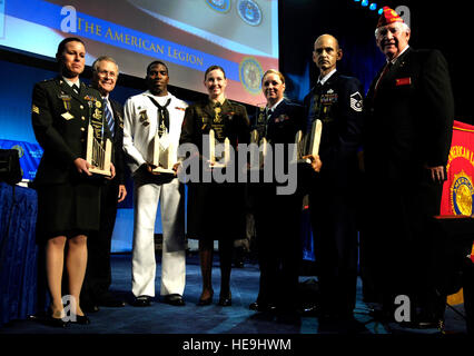 Left to right, U.S. Army Sgt. Renee E. Kraus, U.S. Defense Secretary Donald H. Rumsfeld, U.S. Navy Petty Officer 2nd Class Dempsey L. Tomblin, U.S. Marine Corps Sgt. Kristianna M. Huntington, U.S. Coast Guard Petty Officer 2nd Class Katie S. Anthony, U.S. Air Force Senior Airman Edward J. Slavik, and American Legion National Commander Thomas L. Bock pose for a photograph during the 88th American Legion national convention in Salt Lake City, Utah, Aug. 29, 2006.  The Spirit of Service award was presented to each servicemember for their volunteer service in their local communities. Defense Dept. Stock Photo