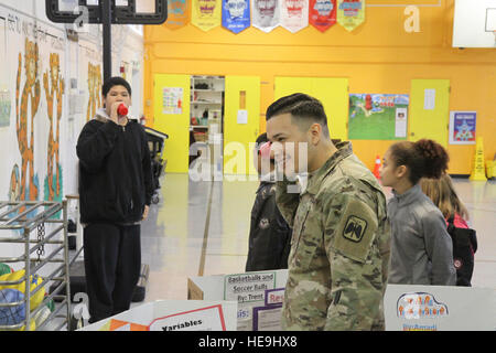 U.S. Army Soldiers assigned to 16th Combat Aviation Brigade judge a science fair at Tillicum Elementary School in Lakewood, Wash., Feb. 4. This event was part of 16th CABs ongoing efforts in the community dedicated to maintaining a strong partnership with local citizens. Stock Photo