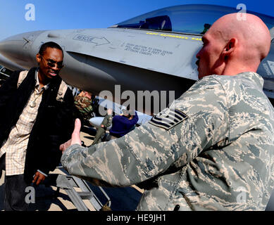 F-16 Crew Chief U.S. Air Force Tech. Sgt. William Brown tells Rapper D-Roc of the duo The Ying Yang Twins about F-16 capabilities during a visit to Kunsan Air Base, Korea, Nov. 12, 2008. D-Roc is on a USO tour accompanying Vice Chairman of the Joint Chiefs of Staff U.S. Marine Gen. James E. Cartwright.  Air Force Master Sgt. Adam M. Stump. (Released) Stock Photo