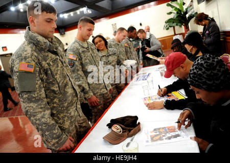 Soldiers stand in line to get autographs from USO entertainers during a visit to Camp Casey, Korea, Nov. 12, 2008. The performers are traveling with Vice Chairman of the Joint Chiefs of Staff U.S. Marine Gen. James E. Cartwright.  Air Force Master Sgt. Adam M. Stump. (Released) Stock Photo