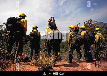 Vandenberg Air Force Base Hot Shot fire fighters prepare to cut a fire line on June 28, 2012 in the Mount Saint Francois area of Colorado Springs, Co. while helping to battle several fires in Waldo Canyon.  The Waldo Canyon fire has grown to 18,500 acres and burned over 300 homes. Currently, more than 90 firefighters from the Academy, along with assets from Air Force Space Command; F.E. Warren Air Force Base, Wyo.; Fort Carson, Colo.; and the local community continue to fight the Waldo Canyon fire.(: Master Sgt. Jeremy Lock) (Released) Stock Photo