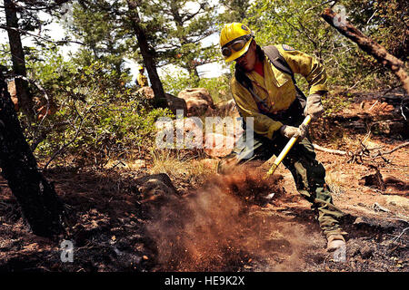 Vandenberg Air Force Base Hot Shot fire fighter Lupe Covarrubias cuts a fire line on June 28, 2012 in the Mount Saint Francois area of Colorado Springs, Co. while helping to battle several fires in Waldo Canyon.  The Waldo Canyon fire has grown to 18,500 acres and burned over 300 homes. Currently, more than 90 firefighters from the Academy, along with assets from Air Force Space Command; F.E. Warren Air Force Base, Wyo.; Fort Carson, Colo.; and the local community continue to fight the Waldo Canyon fire.(: Master Sgt. Jeremy Lock) (Released) Stock Photo