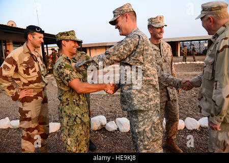 U.S. Army Col. Christopher Beckert and U.S. Navy Captain Craig Woodside, Combined Joint Task Force-Horn of Africa (CJTF-HOA) congratulate U.S. Navy Lt. Brandon Sales and U.S. Marine Capt. Shane Robinette after both completed a Desert Combat Training course at the French Desert Combat Training and Hardening Center, Djibouti, March 6, 2013. The 5th French Marine Regiment invited members of CJTF-HOA to participate in the Desert Combat Training Course to help strengthen the partnership between the military allies.  Airman 1st Class Nicholas Byers Stock Photo