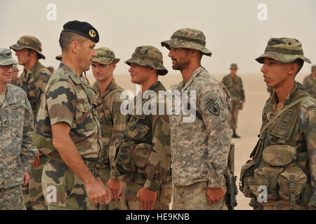 French Lt, Col. Olivier Juillet, Commander, 5th French Marine Regiment, congratulates U.S. Army Sgt. Matthew Belver, 3rd Squadron, 124th Cavalry Regiment, at desert survival course graduation, June 7, 2012, in the Grand Bara Desert, Djibouti.The ten day course taught by French Marines, was attended by U.S. Airmen, Soldiers, Sailors and Marines where they learned desert survival and combat tactics.  Tech. Sgt. Donald R. Allen Stock Photo