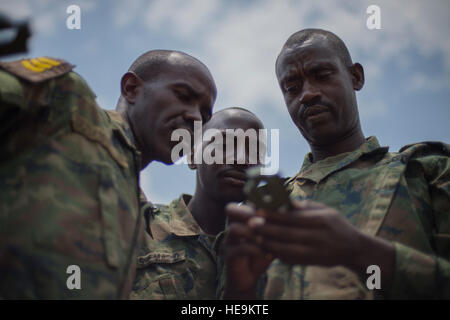 Rwanda Defense Force noncommissioned officers use a compass to gather direction and heading during a land navigation portion of their NCO leadership training Sept. 8, 2016, at the Rwanda Military Academy, Rwanda.  Members of 1st Battalion, 124th Infantry regiment, who are deployed from the Army National Guard to Combined Joint Task Force - Horn of Africa, observed the NCO course to provide advice and critiques to improve the class.  Staff Sgt. Eric Summers Jr.) Stock Photo