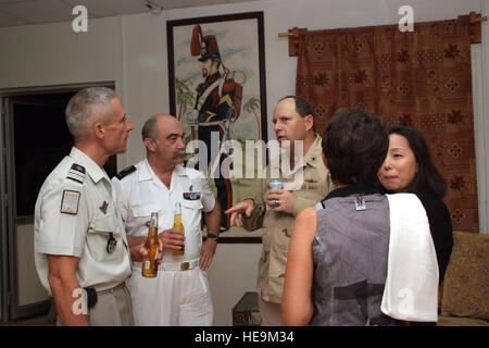 US Navy Rear Admiral Anthony Kurta talks with French Army Col Jean Cremedes (left) and General Phillipe LeForte during a dinner party at Camp Lemonier, Djibouti, Jan 24, 2009. RADM Kurta is the incoming commander of CJTF HOA. Camp Lemonier is the hub of the Combined Joint Task Force, Horn of Africa, providing humanitarian relief, security and anti-terrorism activities to the nations in the Horn of Africa. Stock Photo