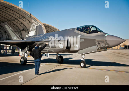 Maj. Laurens Vijge, a Royal Netherlands Air Force pilot, salutes his Lockheed Martin crew chief as he taxis out for the first flight in the F-35A Lightning II.  Vijge became the first RNLAF pilot to fly the joint strike fighter and the flight marks the first sortie for the RNLAF here.  Samuel King Jr.) Stock Photo